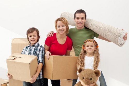 Local removal team handling furniture in a north London flat