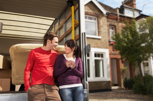 House movers carrying furniture carefully on a Tufnell Park street